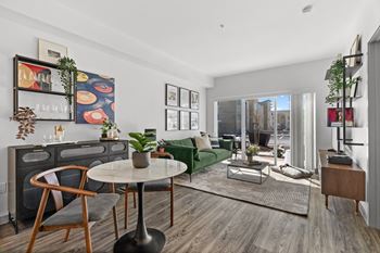 A living room with a green couch and a table