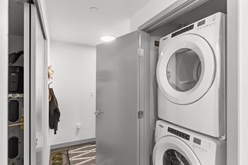 A small laundry room with a washing machine and a dryer