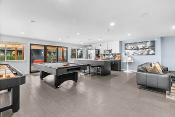 Tacoma apartment for rent - A modern living room with a pool table and a couch.