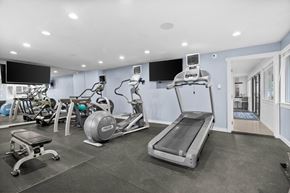 Tacoma apartment for rent - A spacious gym with a variety of equipment including treadmills, stationary bikes, and weight machines.