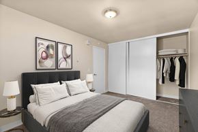 Issaquah apartment for rent - A bedroom with a large bed and a wardrobe.