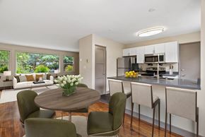 Seattle apartment for rent - A modern kitchen with a dining table and chairs.