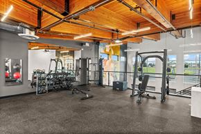 Tacoma apartment for rent - A gym with a variety of equipment including treadmills, weights, and exercise machines.