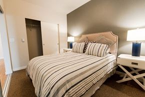 Kent apartment for rent - A bedroom with a bed, nightstand, and lamp. at The Platform, Washington, 98032