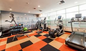 Kent apartment for rent - A gym with a running track and a wall mural that says