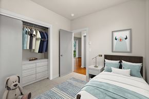 Bellevue apartment for rent - A bedroom with a bed, a wardrobe, and a painting of a penguin on the wall.