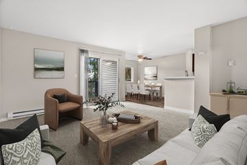 Silverdale apartment for rent - A living room with a brown chair, a coffee table, and a painting on the wall.