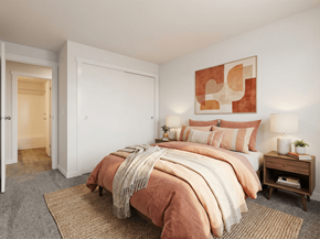 Puyallup apartment for rent - A bedroom with a large bed and a painting on the wall.
