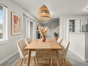 Puyallup apartment for rent - A dining room with a wooden table and chairs.