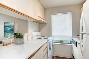 Seattle apartment for rent - A kitchen with white appliances and a white counter top.