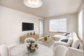 Seattle apartment for rent - A living room with a white couch, a coffee table, and a flat-screen TV.