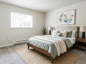 Tacoma apartment for rent - A bedroom with a bed, nightstand, and a painting on the wall.