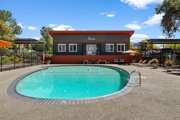 Renton apartment for rent - A pool in front of a house with a red and grey exterior.