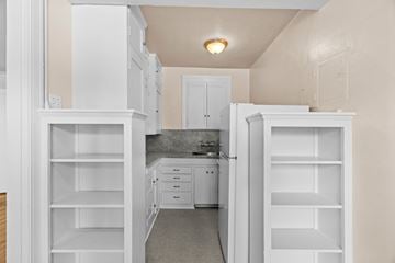 Seattle apartment for rent - A kitchen with white cabinets and a countertop.