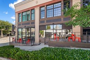 Seattle apartment for rent - A building with a red awning and a glass door.