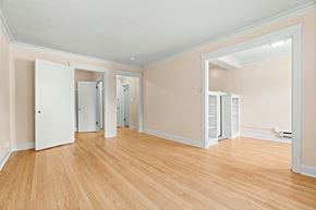 Seattle apartment for rent - A room with wooden floors and white walls.