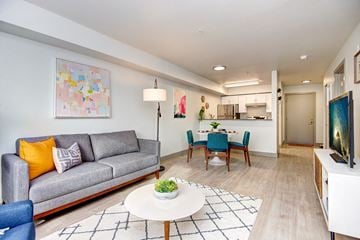 Seattle apartment for rent - a living room and dining room with a couch and a table