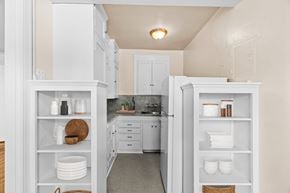 Seattle apartment for rent - A kitchen with white cabinets and a countertop with a sink.