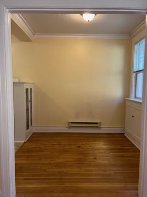 Seattle apartment for rent - A room with wooden floors and white walls.