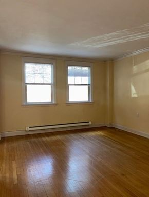 Seattle apartment for rent - A room with wooden floors and two windows.