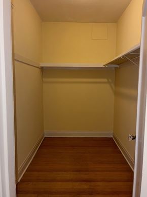 Seattle apartment for rent - A small, empty room with a wooden floor and a white door.