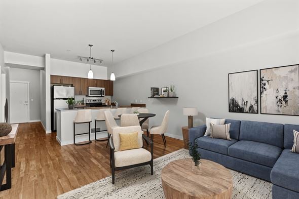 Kent apartment for rent - A modern living room with a blue couch and a dining table.