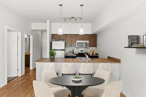 Kent apartment for rent - A modern kitchen with a dining table and chairs.