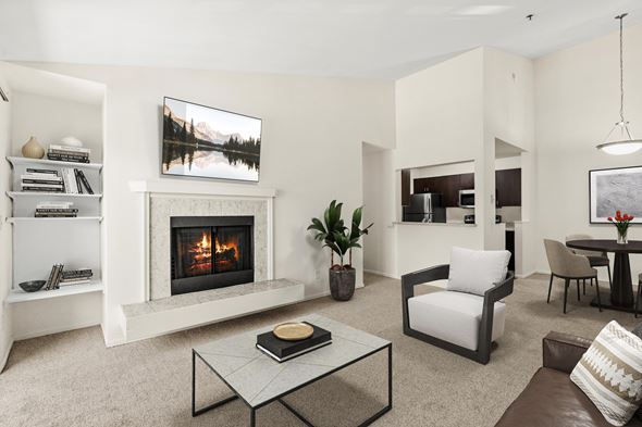 Kent apartment for rent - A modern living room with a fireplace and a painting of a lake on the wall.