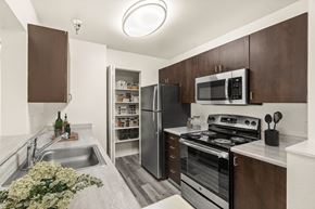 Kent apartment for rent - A kitchen with brown cabinets and a stainless steel refrigerator.