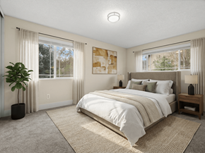 Issaquah apartment for rent - A bedroom with a large bed and a plant.