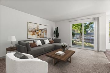 Silverdale apartment for rent - A living room with a grey couch, a white chair, a coffee table, and a painting on the wall.