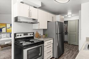 Silverdale apartment for rent - A modern kitchen with a black stove and a black refrigerator.