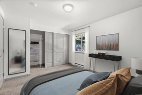 Silverdale apartment for rent - A bedroom with a large bed and a painting on the wall.