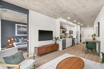 Seattle apartment for rent - A modern living room with a white couch and a wooden coffee table.