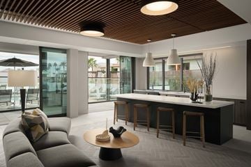 Scottsdale apartment for rent - A modern living room with a grey sofa and a wooden ceiling.