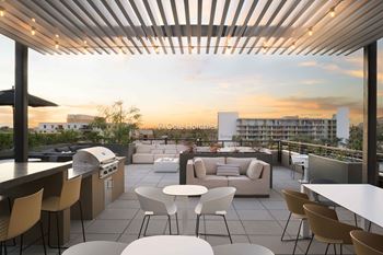 Rooftop deck with bbq grills, outdoor kitchen, and soft seating