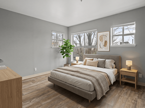 Seattle apartment for rent - A bedroom with a large bed and a wooden nightstand.