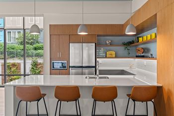 A kitchen with a large island and four chairs
