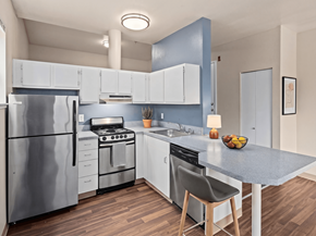 Seattle apartment for rent - A modern kitchen with a stainless steel refrigerator and a grey countertop.