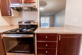A kitchen with a stove top oven and a sink