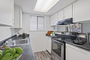Tacoma apartment for rent - a kitchen with stainless steel appliances and white cabinets at The Verandas, Washington, 98466