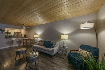 Phoenix apartment for rent - A living room with a white couch and a wooden ceiling.