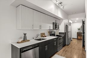 Seattle apartment for rent - A modern kitchen with dark wood cabinets and stainless steel appliances.