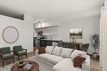 Seattle apartment for rent - A living room with a white couch and green chairs.