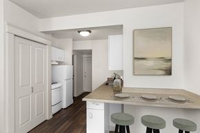 Seattle apartment for rent - A kitchen with a table set for two with a painting hanging on the wall.