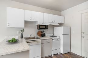 Seattle apartment for rent - A kitchen with white appliances and cabinets.
