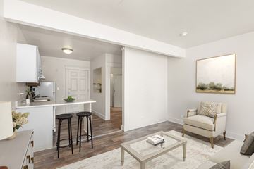 Seattle apartment for rent - A living room with a white couch and a painting on the wall.
