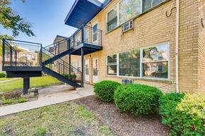 Arlington Heights apartment for rent - A brick building with a black metal staircase outside.