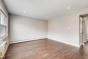 Arlington Heights apartment for rent - A room with wooden floors and white walls.