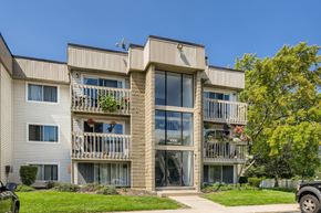 Schaumburg apartment for rent - a view of a building with balconies and a lawn